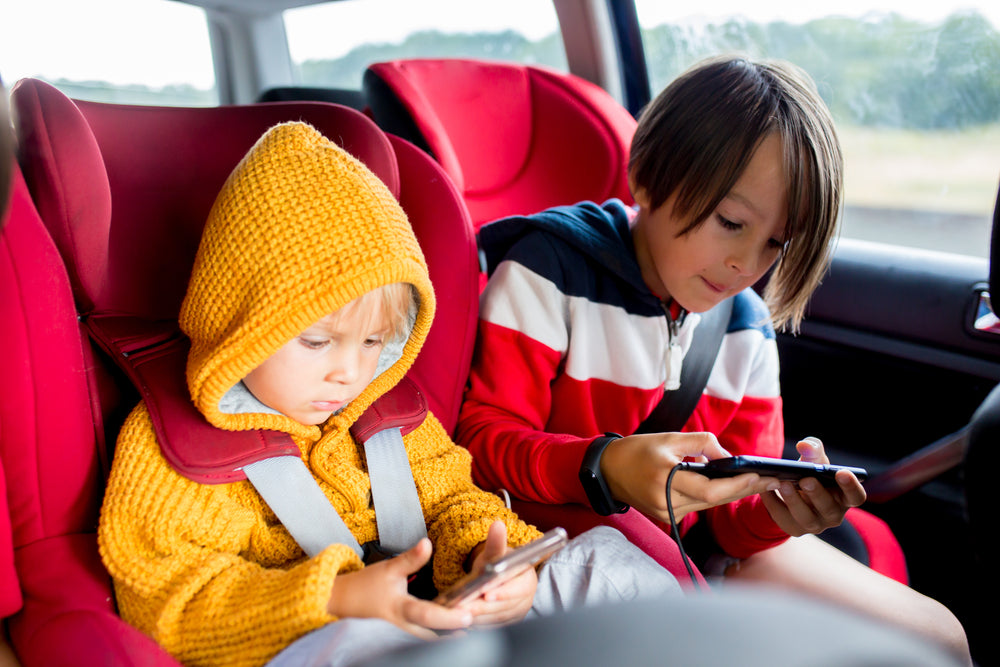 three children boys traveling car